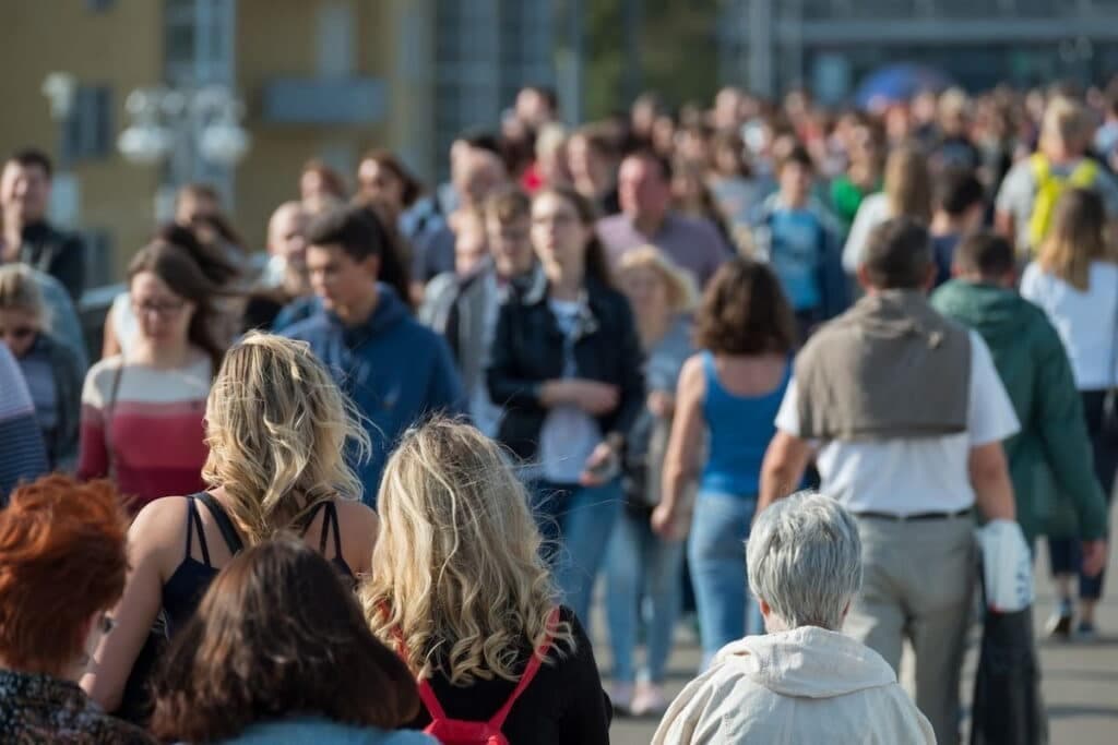 A crowd of people walking on the street.